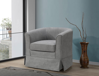 The Tucker Woven Fabric Swivel Barrel Chair in light gray sits beside a brown vase with branches, set against a blue wall near a large window overlooking the balcony.