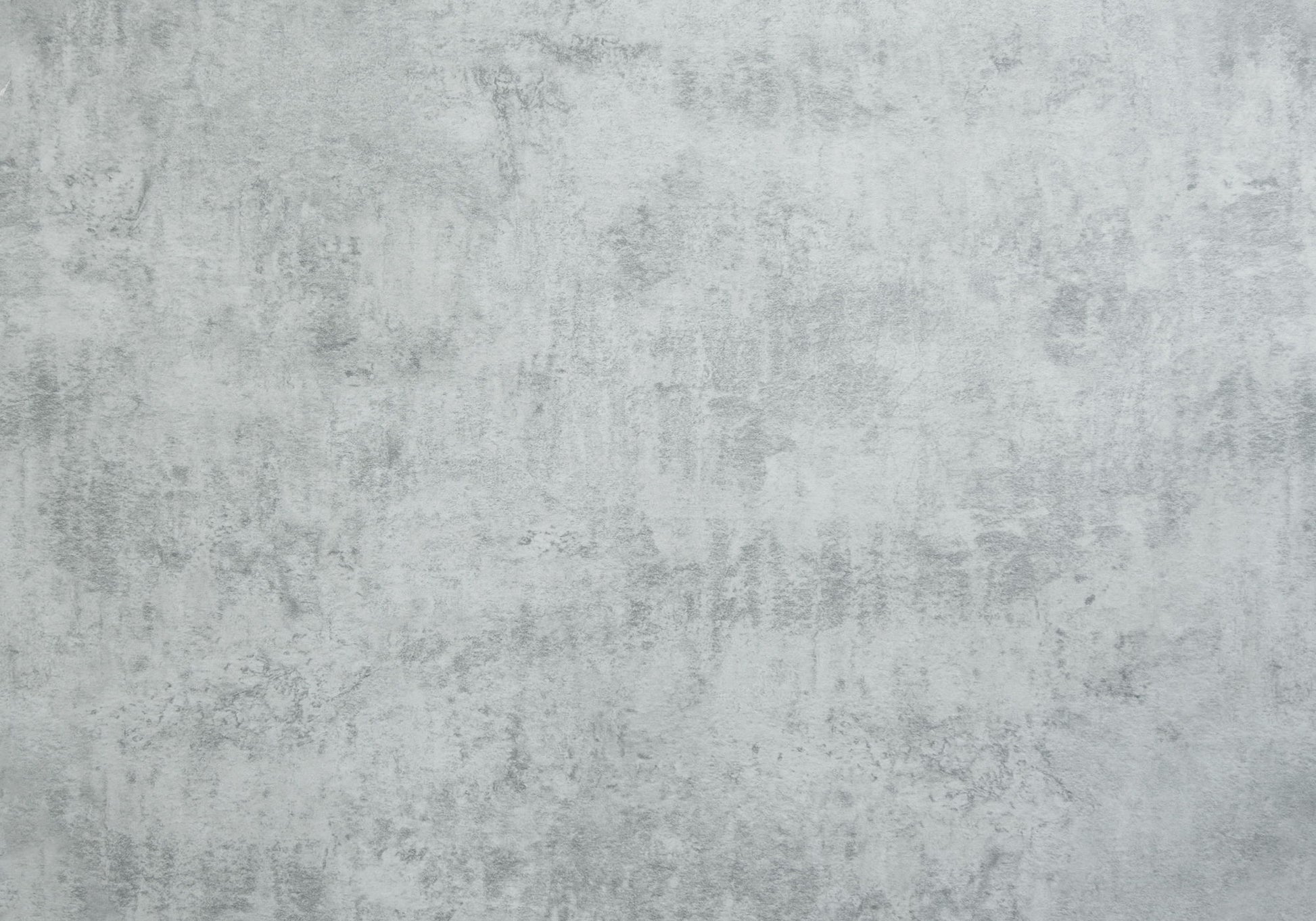 The Table is rectangular with a contemporary design, featuring a light gray finish and subtle shade variations for an industrial, minimalistic look that suits versatile placement.