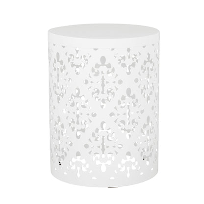 The Outdoor Metal Modern Design End Table is a round, white metal side table featuring an intricate decorative cut-out pattern on its sides and a solid top.