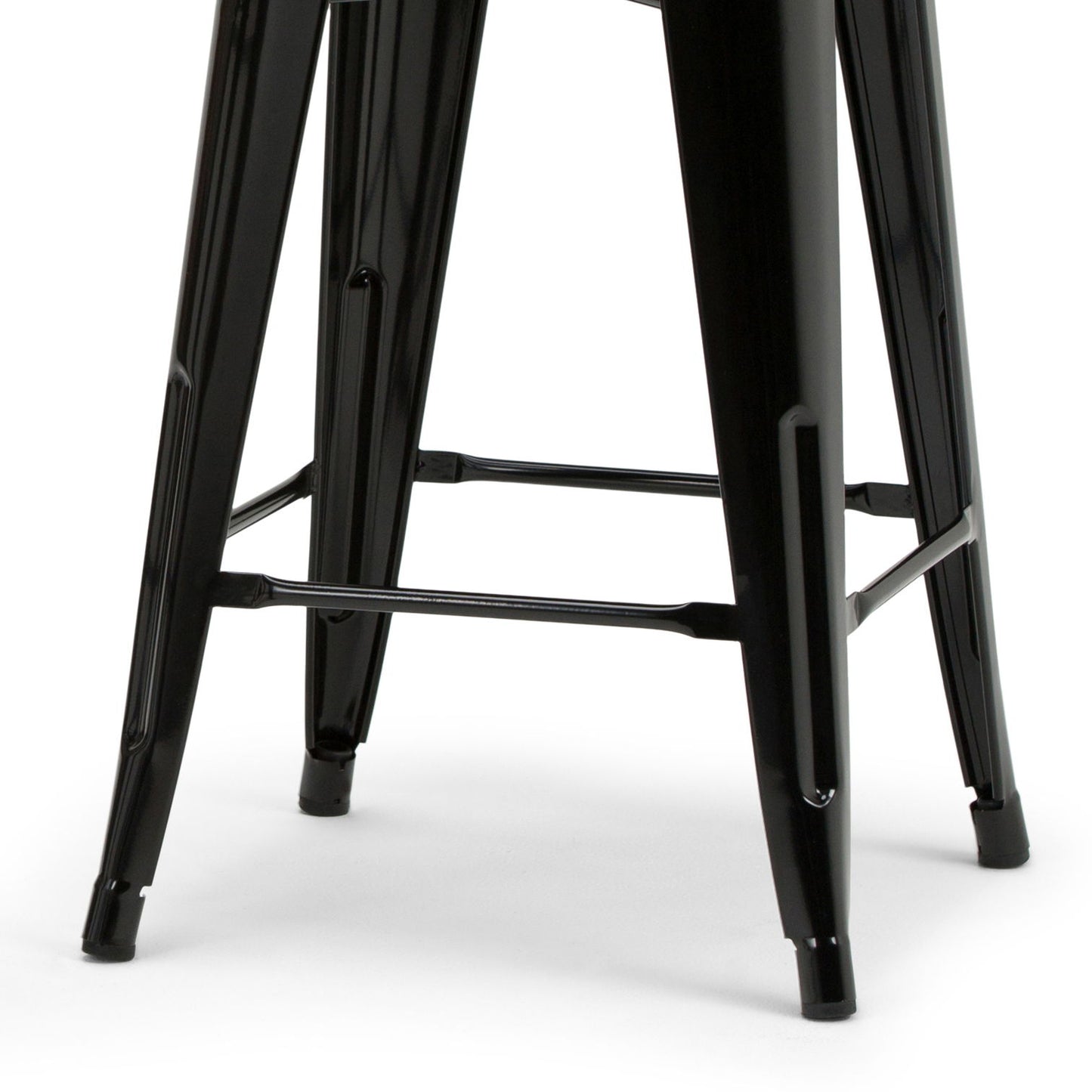 Close-up view of the black metal legs of the Rayne - Multifunctional Metal Stool, featuring crossbars for added support and stability, set against a white background.