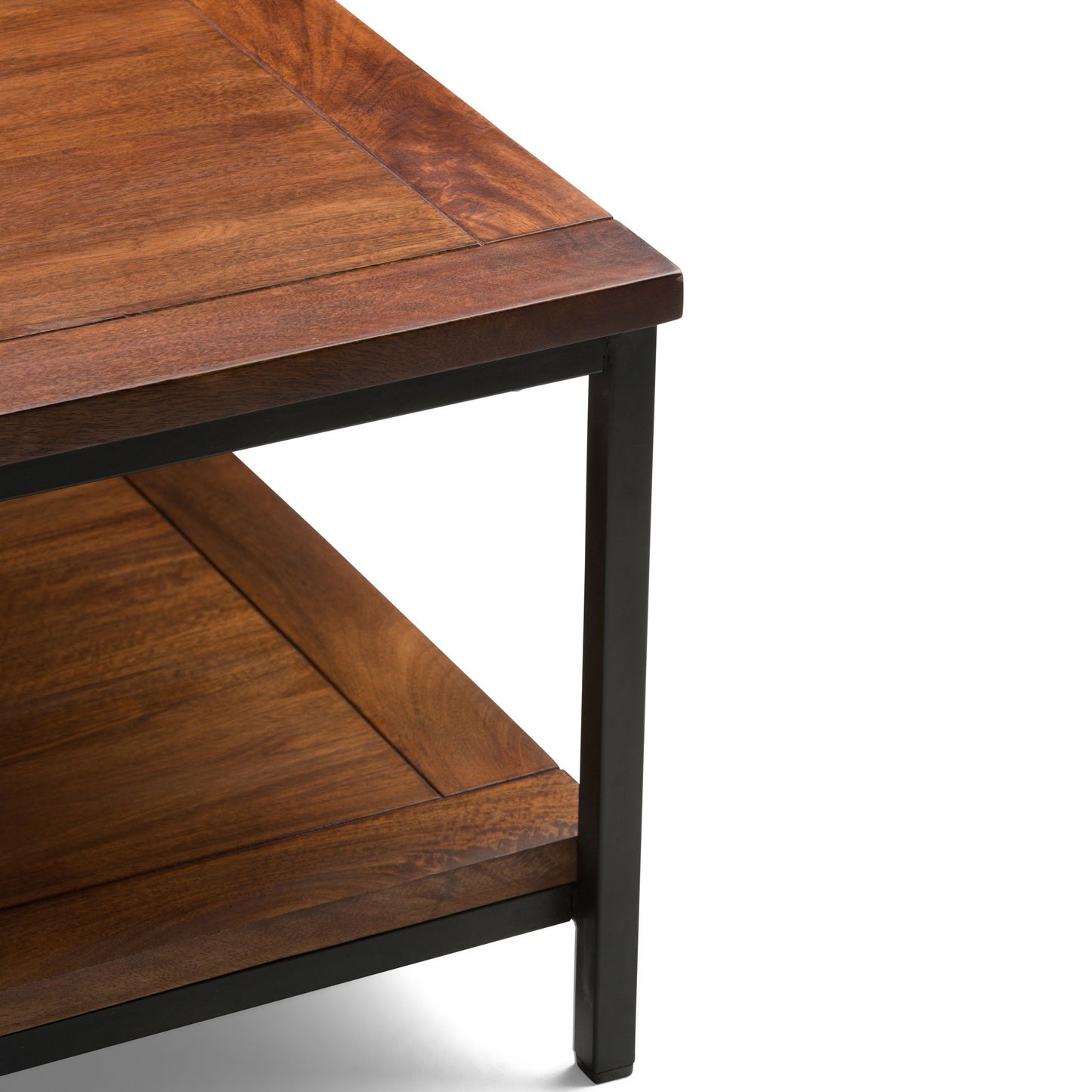 Close-up of the Skyler - Handcrafted Table’s corner, featuring a wooden surface with visible grain, a lower shelf, and a black metal frame that highlights its sturdy construction.