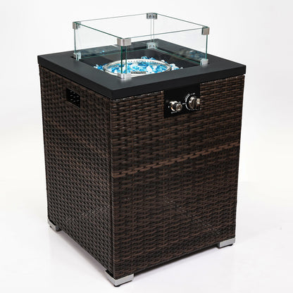 The Propane Gas Square Fire Pit features a tile tabletop, stylish wicker base, glass wind guard, black top, control knobs, and blue fire glass stones in the burner, shown on a white background.