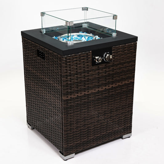 The Propane Gas Square Fire Pit features a tile tabletop, stylish wicker base, glass wind guard, black top, control knobs, and blue fire glass stones in the burner, shown on a white background.