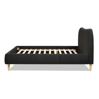 Side view of the Roman - Curved Headboard Upholstered Platform Bed featuring a tall, rounded black headboard, wooden slats, and light wood legs, shown without a mattress.