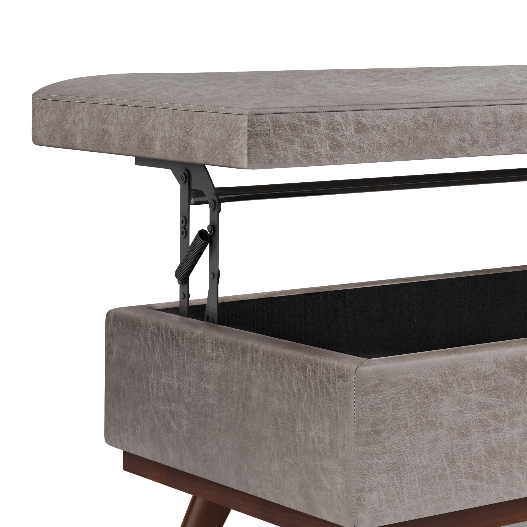 A close-up of the Owen - Lift Top Large Coffee Table Storage Ottoman in gray upholstery, showing its cushioned lid lifted by black metal hinges and a spacious storage compartment inside, with wooden legs and mid-century style.