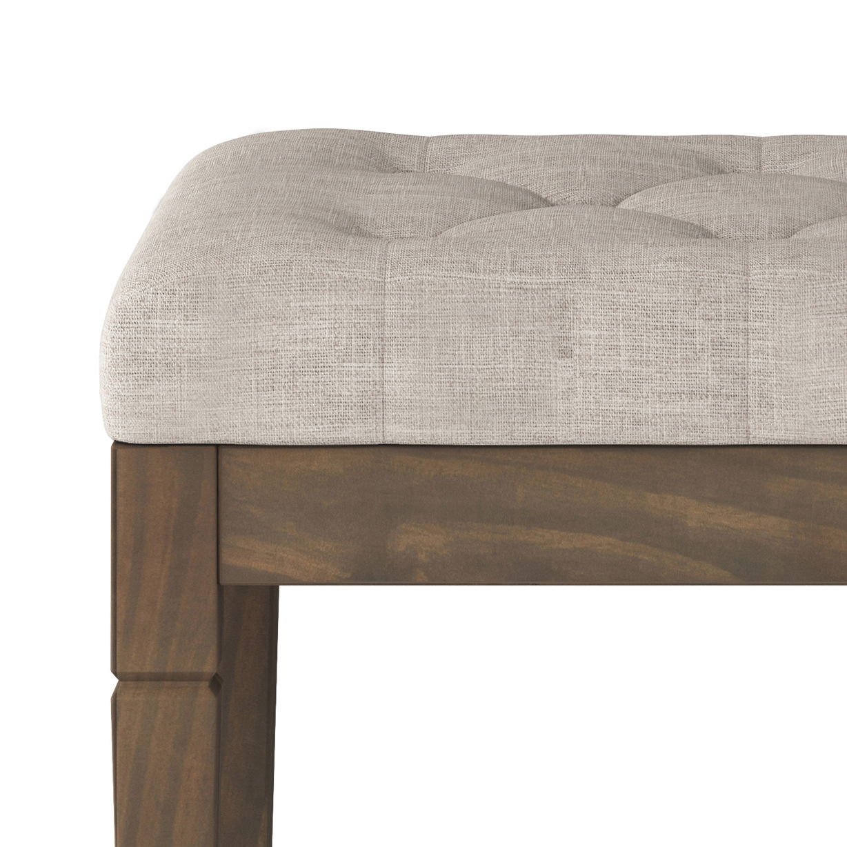 A close-up of the Waverly Upholstered Tufted Ottoman Bench shows its light beige tufted cushion and a wooden frame with a dark brown finish.