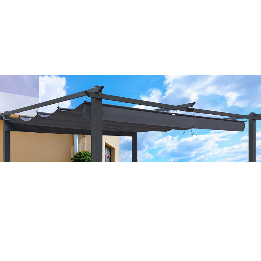 The Replacement Canopy Top Cover Fabric for Outdoor Patio Retractable Pergola Sun-Shelter is displayed with its dark gray canopy extended beneath a bright blue, partly cloudy sky and adjacent to a beige building.