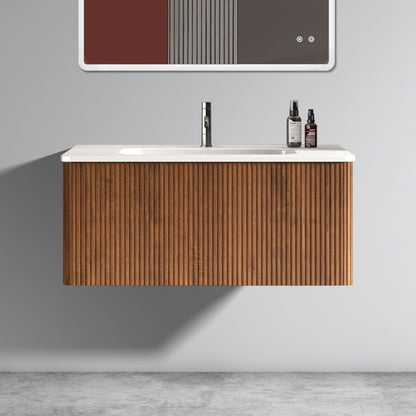 The Etna Striped Bathroom Vanity features a ribbed wooden cabinet, ceramic sink, and chrome faucet. Two bottles sit on the right of the white countertop. Minimalist decor with a gray wall and concrete floor completes the modern look.