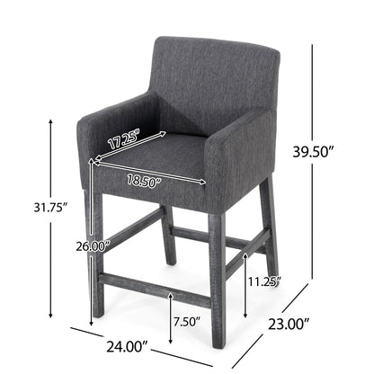The Serenitia Upholstered Counter Chair With Straight Arm features dark gray upholstery, wooden legs, and armrests. Dimensions: height 39.5", seat height 26", width 24", depth 23", arm height 31.75", seat depth 17.25", seat width 18.5".