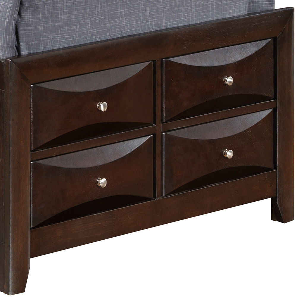 The Marilla Storage Bed With Bookcase Headboard features a dark wood footboard with four rectangular drawers, each adorned with a silver knob and wave-like front design. A gray upholstered mattress is partially visible on top.