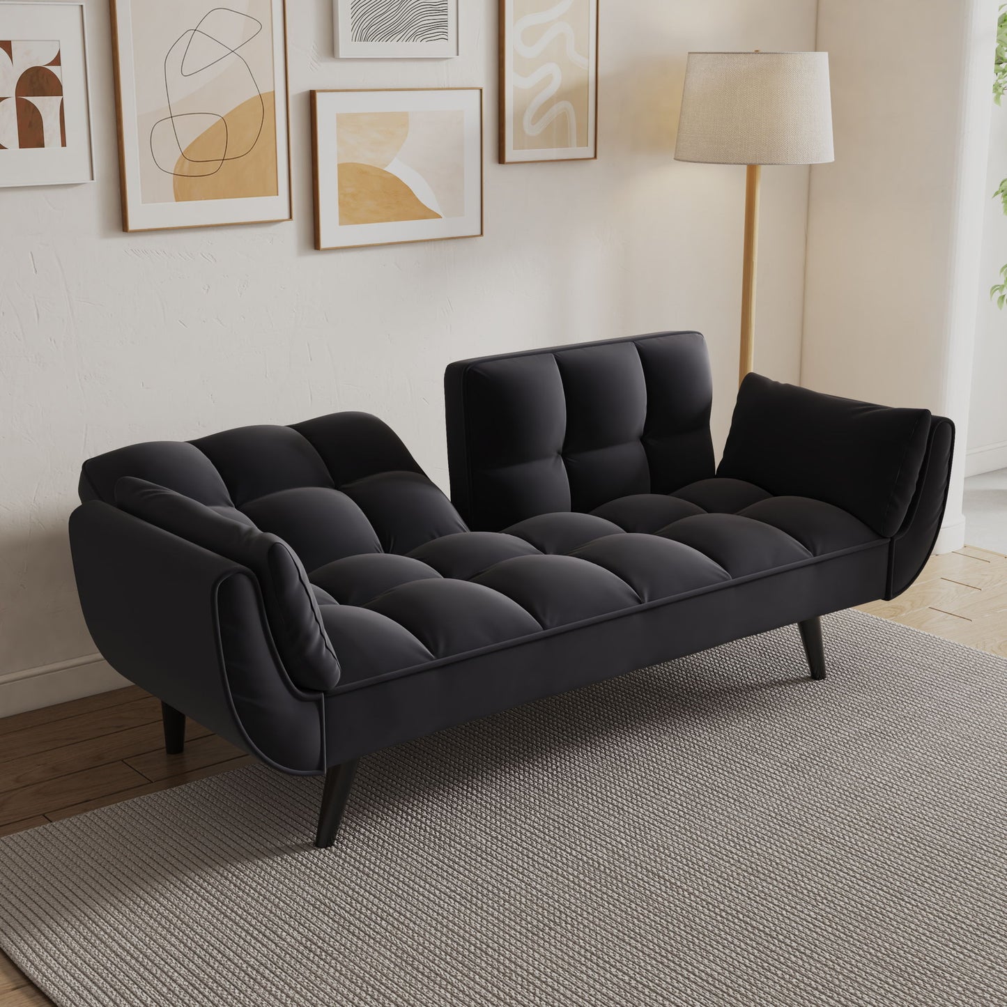 The Sofa Soft with two armrests and throw pillow offers comfort and style, fitting perfectly in an apartment bedroom or small space, set atop a gray textured rug beside abstract art and a tall floor lamp.