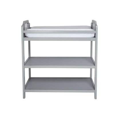 The Celeste - Changing Table features a gray wooden frame, a white cushioned pad on top, and two open shelves below, all shown against a plain white background.