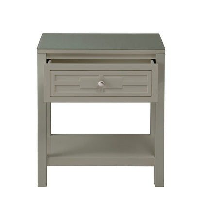 The Dylan nightstand features a gray finish, a glass top, a single drawer with a round knob, an open lower shelf, and a simple modern design.