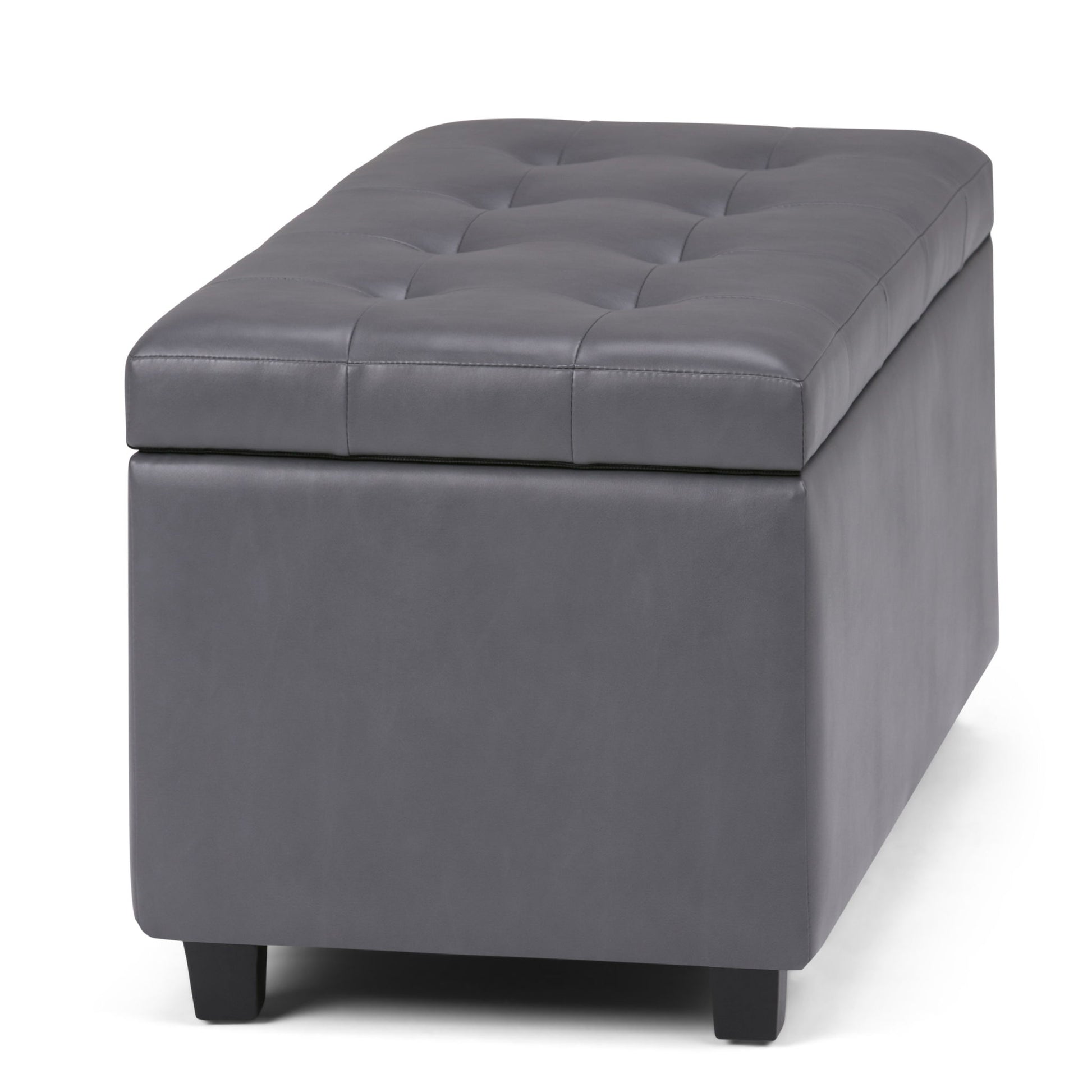 The Cosmopolitan Upholstered Storage Ottoman features a rectangular grey design with a tufted lid and short black legs, shown against a white background.