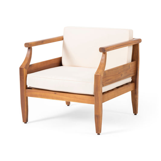 The Outdoor Club Chair With Recessed Arms And Cushions features a light wood frame, curved armrests, and off-white seat and backrest cushions, displayed against a plain white background.