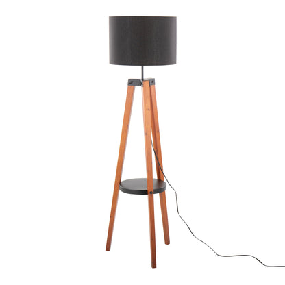 The Compass Mid Century Modern Floor Lamp features a black cylindrical shade, wooden tripod legs, a small round shelf, and a visible black power cord.