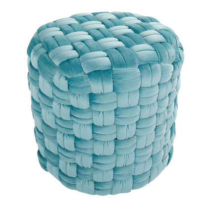 The Braided - Versatile Round Ottoman features a chunky, woven design in soft light blue velvet, creating a plush and cushiony look. Photographed against a white background.
