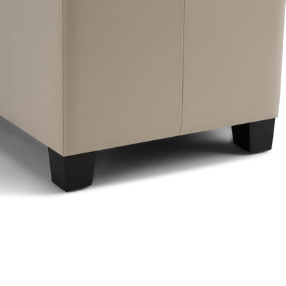 Close-up of the bottom corner of the Dover Upholstered Storage Ottoman Bench in beige, featuring dark wooden legs and visible fabric stitching.