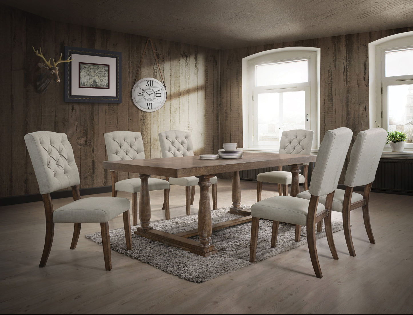 A dining room featuring the Bernard - 7 Pieces Dining Room Set, a wooden table with six upholstered chairs, complemented by a textured rug, wood-paneled walls, two large windows, a wall clock, framed art, and a mounted antler decoration.