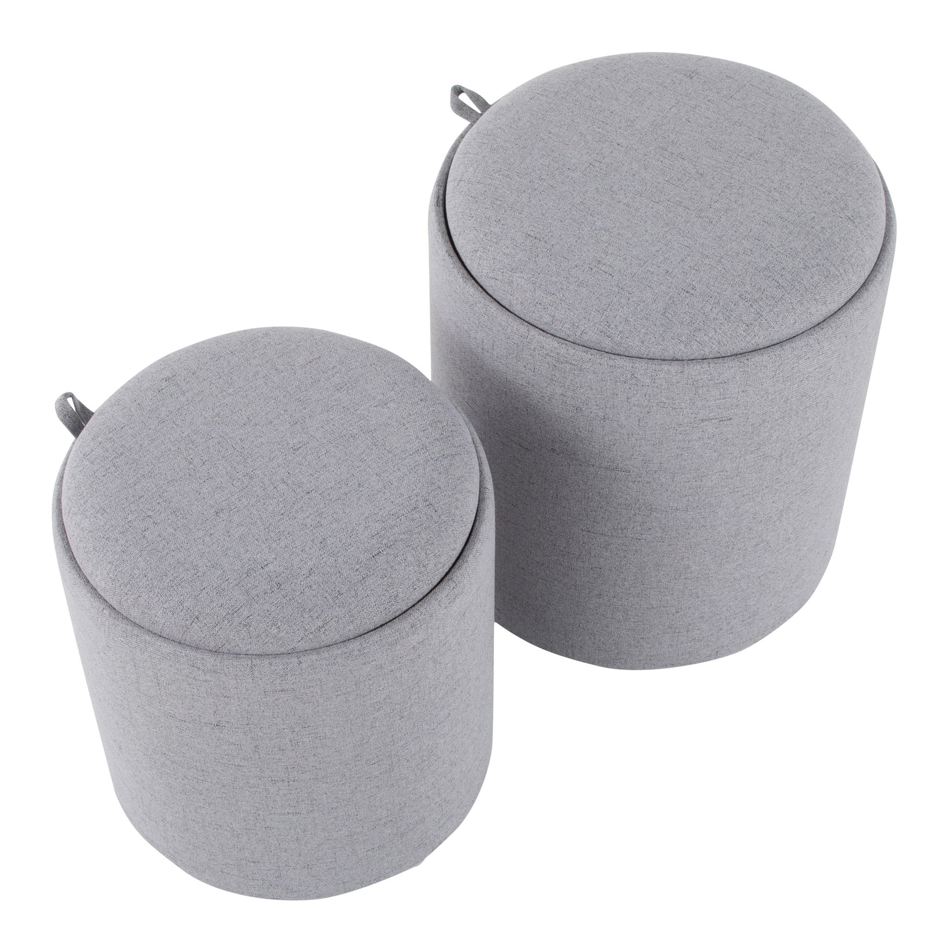 The Tray - Contemporary Nesting Ottoman Set features two round, light gray ottomans in different sizes, each with a fabric cover and a small loop handle on the side near the top.