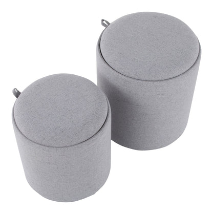 The Tray - Contemporary Nesting Ottoman Set features two round, light gray ottomans in different sizes, each with a fabric cover and a small loop handle on the side near the top.
