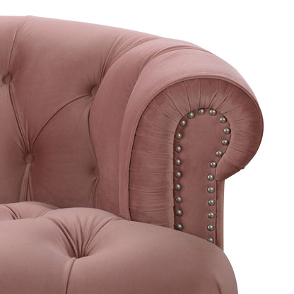 Close-up of the La Rosa - Victorian Chesterfield Tufted Sofa in pink velvet, featuring a rolled armrest, button tufting, and silver nailhead trim accents.