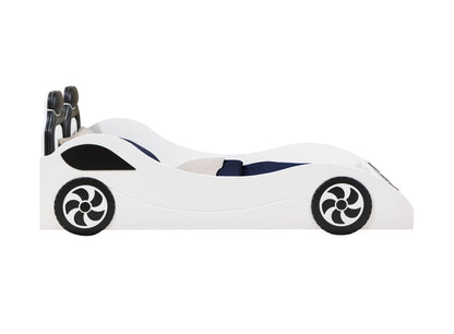 The Colen - Twin Car Bed With LED is a white children's bed styled like a race car, featuring black wheels, sleek side design, and navy blue and gray bedding.