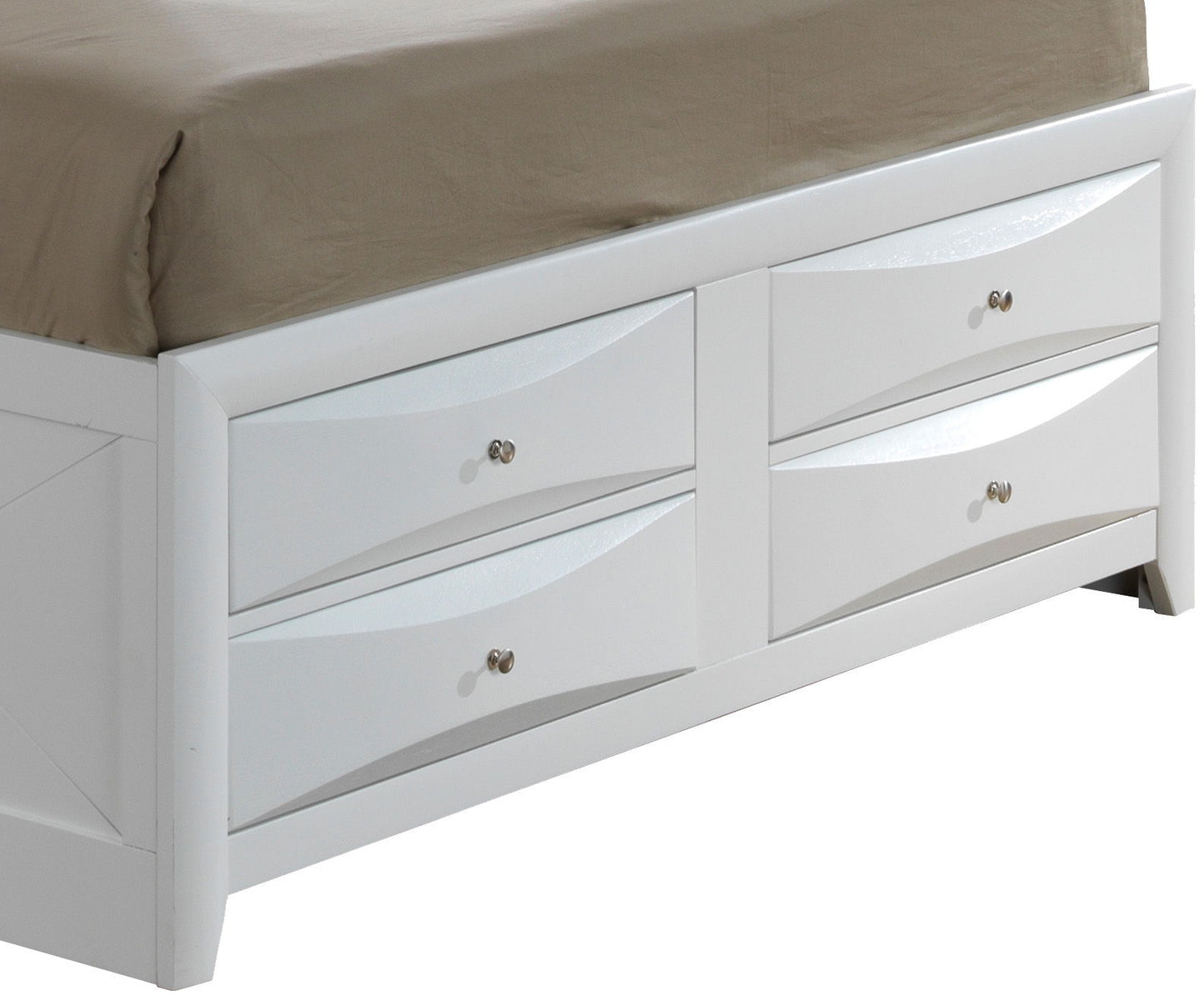 A close-up of the Marilla Storage Bed With Bookcase Headboard, featuring a white wooden frame with four drawers, each with a silver knob. A beige sheet is partially visible on the mattress above the drawers.