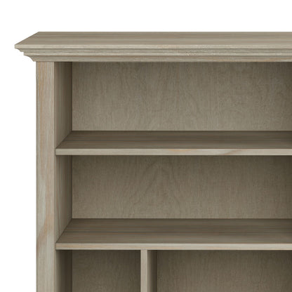 A close-up of the Amherst Multi Cube Bookcase and Storage Unit in light brown wood shows its three empty shelves, with only the upper portion and left side visible against a plain background.