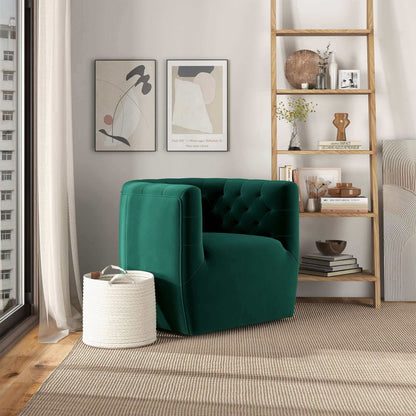 A modern living room with the Delaney Ergonomic Design Swivel Chair in green velvet, a woven basket, a wooden bookshelf with decor, abstract wall art, and sunlight streaming through the window.