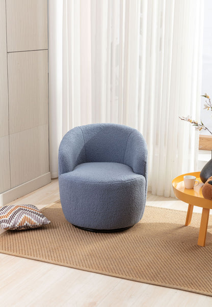 The Teddy Fabric Swivel Accent Armchair Barrel Chair with a powder coating metal ring sits on a tan rug in a bright room with light wood floors, sheer white curtains, a yellow coffee table, and a striped pillow on the floor.