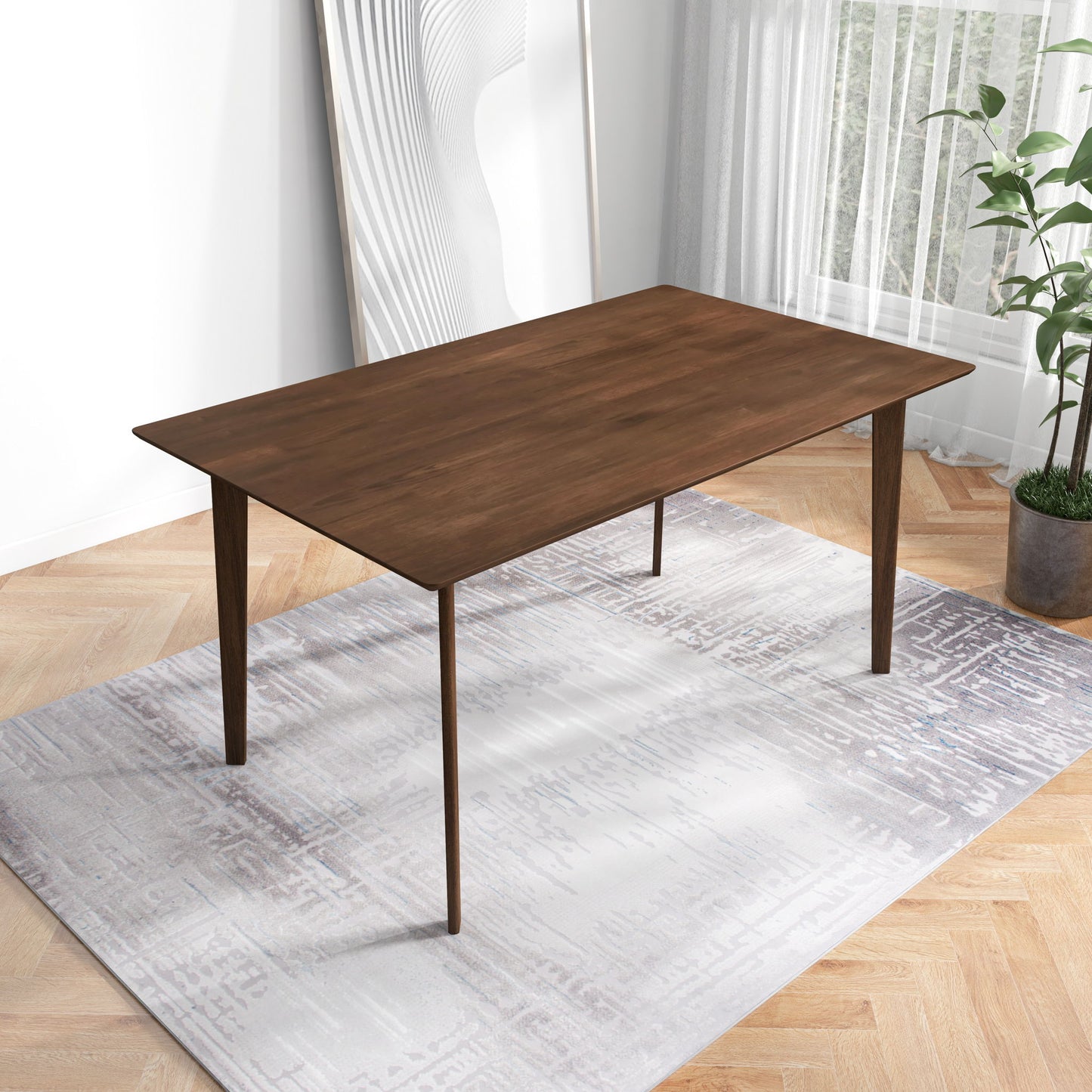 The Carlos Dining Table with tapered legs stands on a light patterned rug in a bright room featuring a large window, potted plant, and abstract artwork in the background.