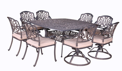 The Square 8 Person 64" Long Aluminum Dining Set With Cushions features an ornate metal table and eight matching chairs with light cushions; two chairs have swivel bases, and the others have standard legs.