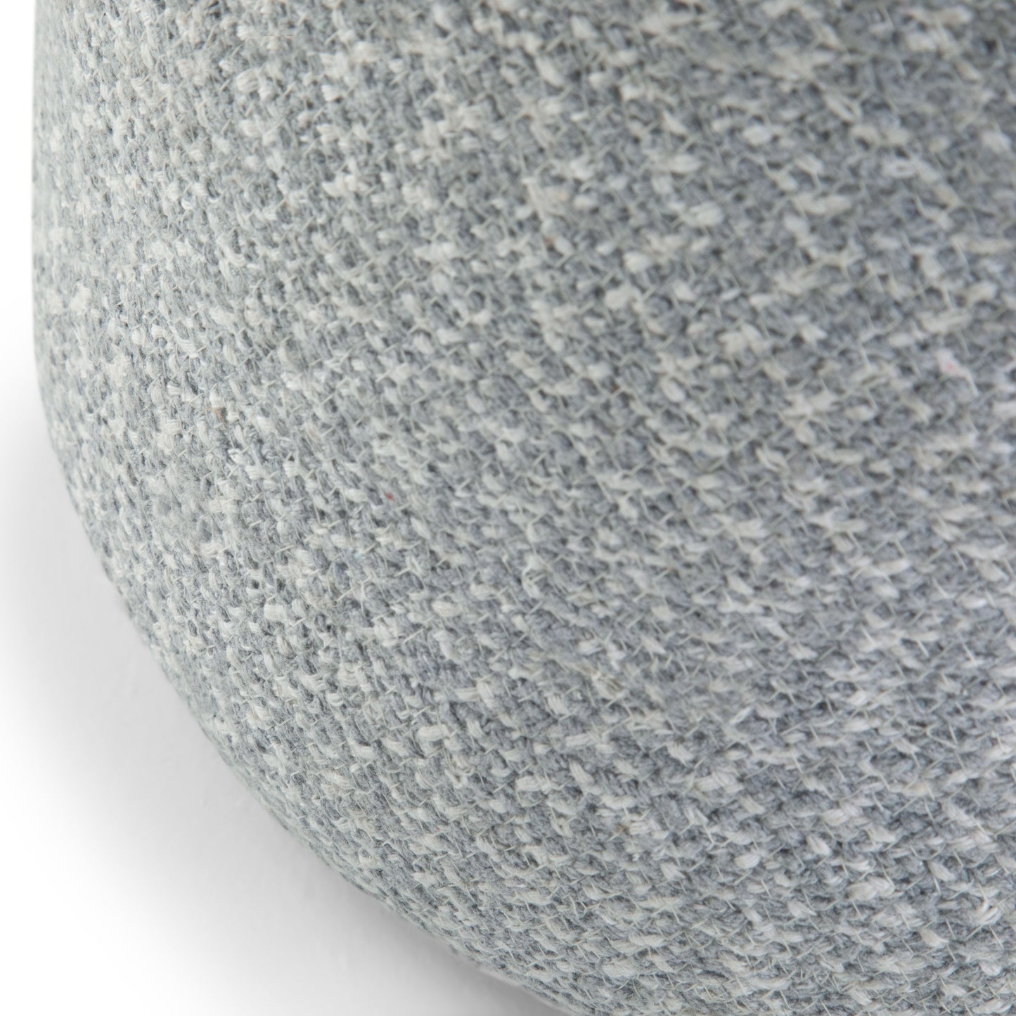 Close-up of the Bayley - Versatile Round Braided Pouf, featuring a textured, light gray woven fabric on its rounded surface.