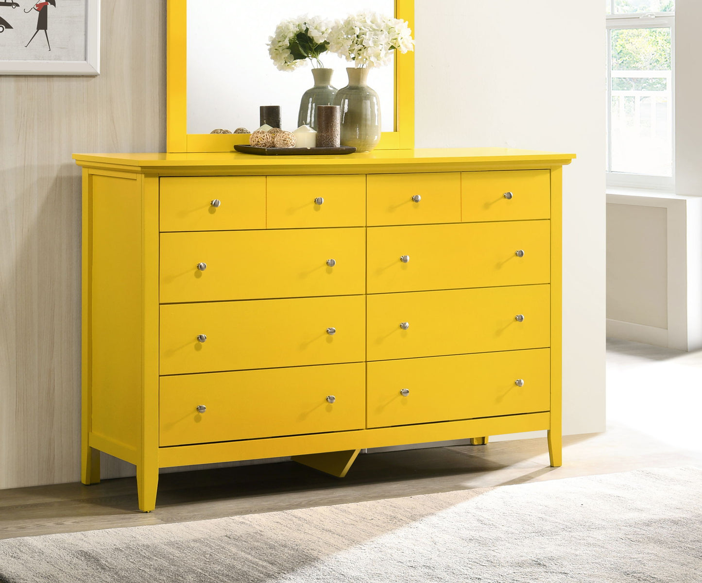 The Elegant Casual Dresser For Any Room, featuring nine drawers with silver knobs in a bright yellow finish, stands in a modern room topped with vases of white flowers, a mirror, and decor as sunlight filters through a nearby window.