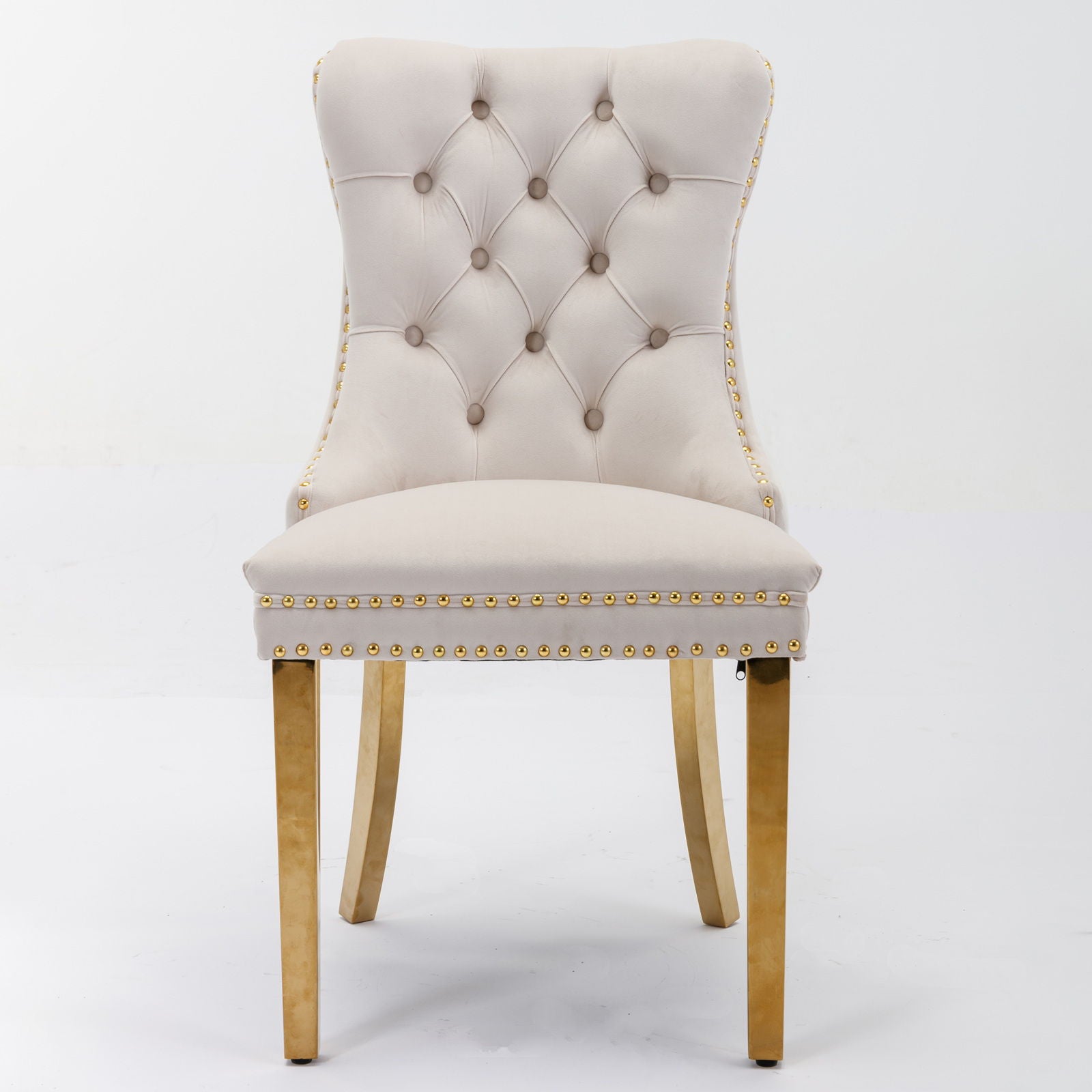 The Nikki set includes two modern, high-end velvet dining chairs with tufted backs, nailhead trim, and golden stainless steel plated legs, shown against a plain white background.
