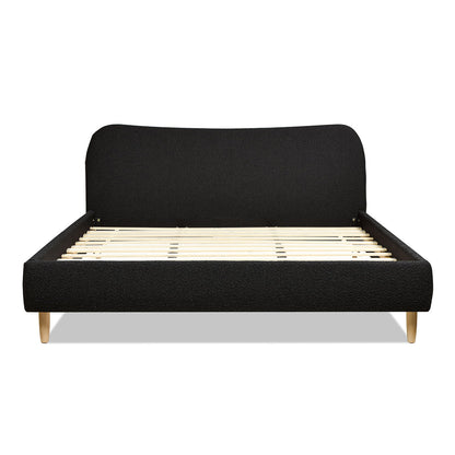 The Roman Curved Headboard Upholstered Platform Bed features a modern black design, curved headboard, wooden slats for support, and light wood legs, shown against a white background.