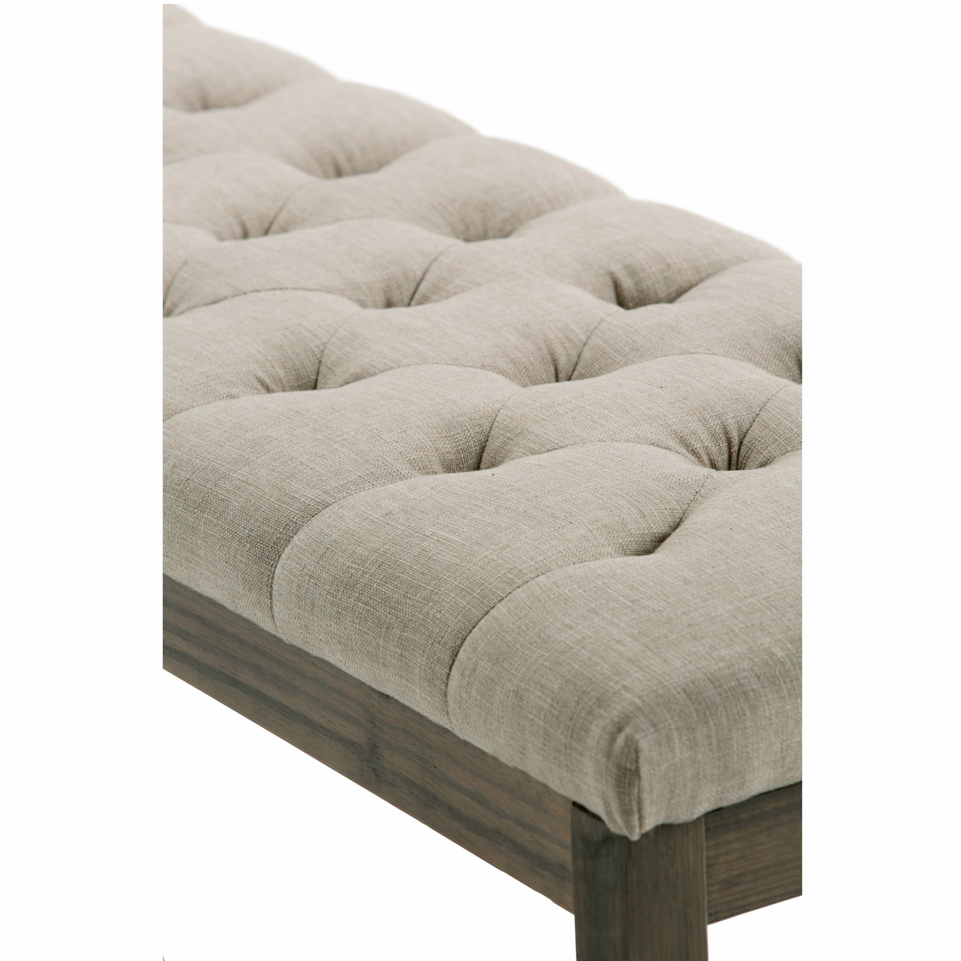 Close-up of the Waverly - Upholstered Tufted Ottoman Bench featuring beige, textured linen-like fabric with visible stitching and a dark wooden frame and legs.