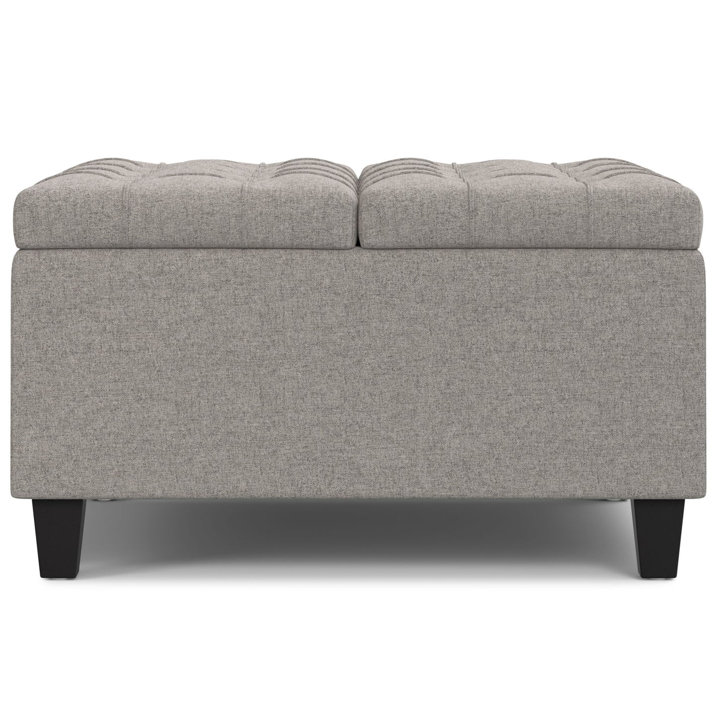 The Harrison Upholstered Coffee Table Storage Ottoman features a rectangular gray tufted top and short black legs, displayed from the front on a white background.