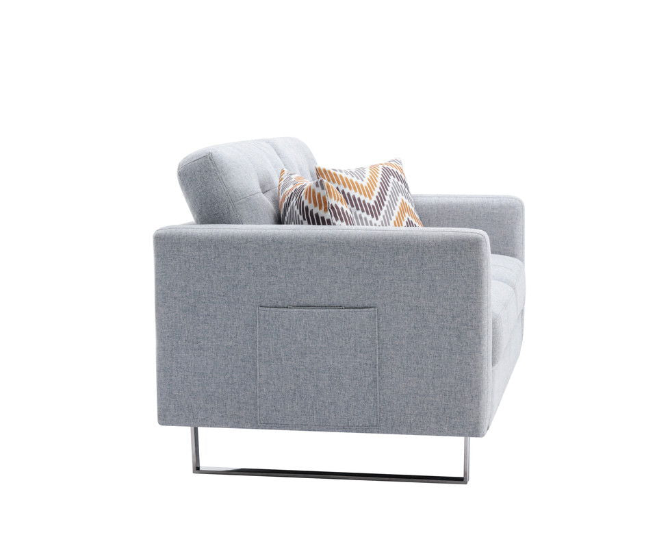 The Victoria Linen Fabric Loveseat features modern metal legs, handy side pockets, and includes decorative zigzag yellow, gray, and white pillows. Photographed from the side on a white background.