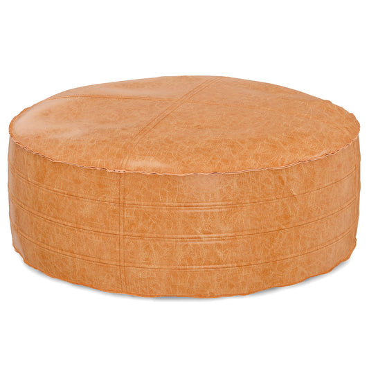 The Brody - Round Pouf is a large, round ottoman made of light brown leather with visible stitching and a subtly textured surface, shown on a white background.