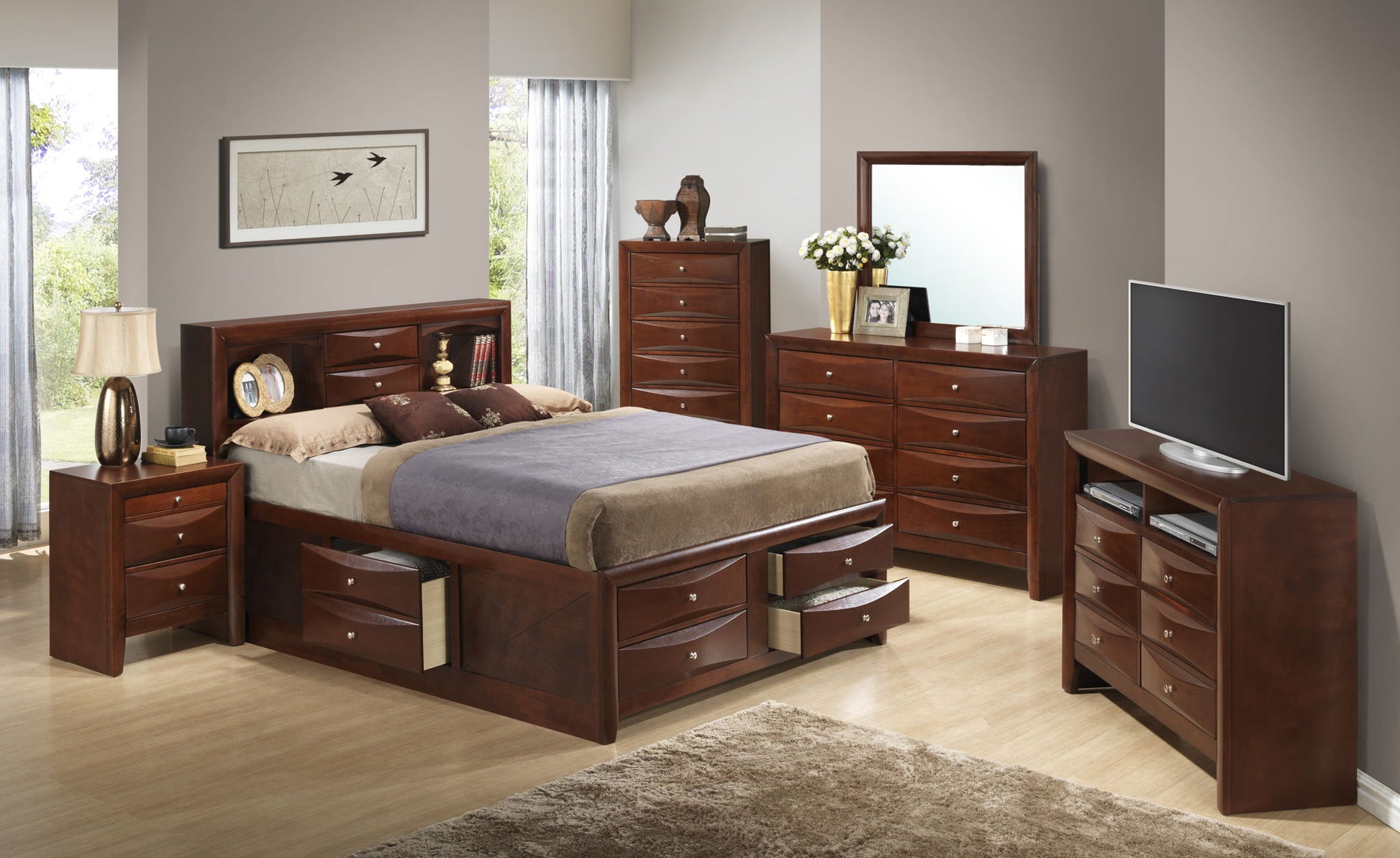 A modern bedroom featuring the Marilla Storage Bed With Bookcase Headboard, dark wood nightstands, dressers, a mirror, TV, lamp, flowers, and framed wall art. Light walls and wood flooring complete the look.