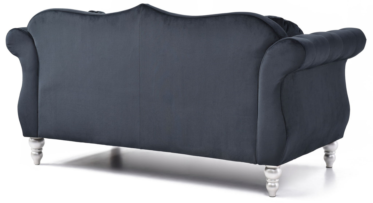 The Stylish Flared Arm Loveseat features dark blue velvet, rolled arms, a curved backrest, and short shiny silver legs, shown from the back against a white background.