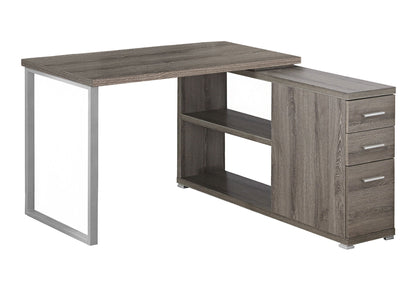 This contemporary L-shaped computer desk features three right-side storage drawers, two central open shelves, a gray finish, and sturdy left-side metal legs—ideal for any home office or modern corner workspace.