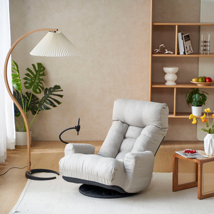 An Adjustable Swivel Lounge Chair with a 360-degree rotating seat and headrest support sits by a wooden floor lamp and low flower table in a modern living room adorned with plants and shelves.