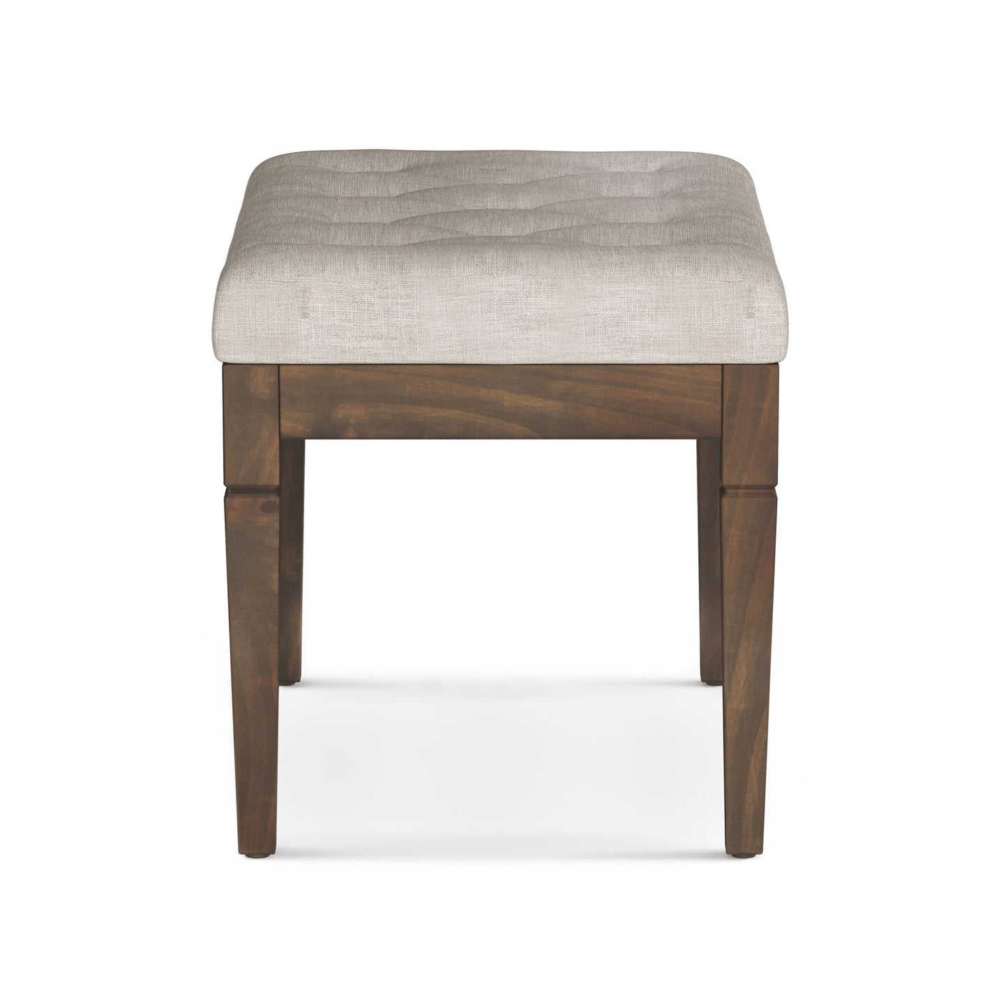 The Waverly Upholstered Tufted Ottoman Bench features a square wooden frame with four legs and a padded, light beige tufted seat, displayed from the front on a white background.