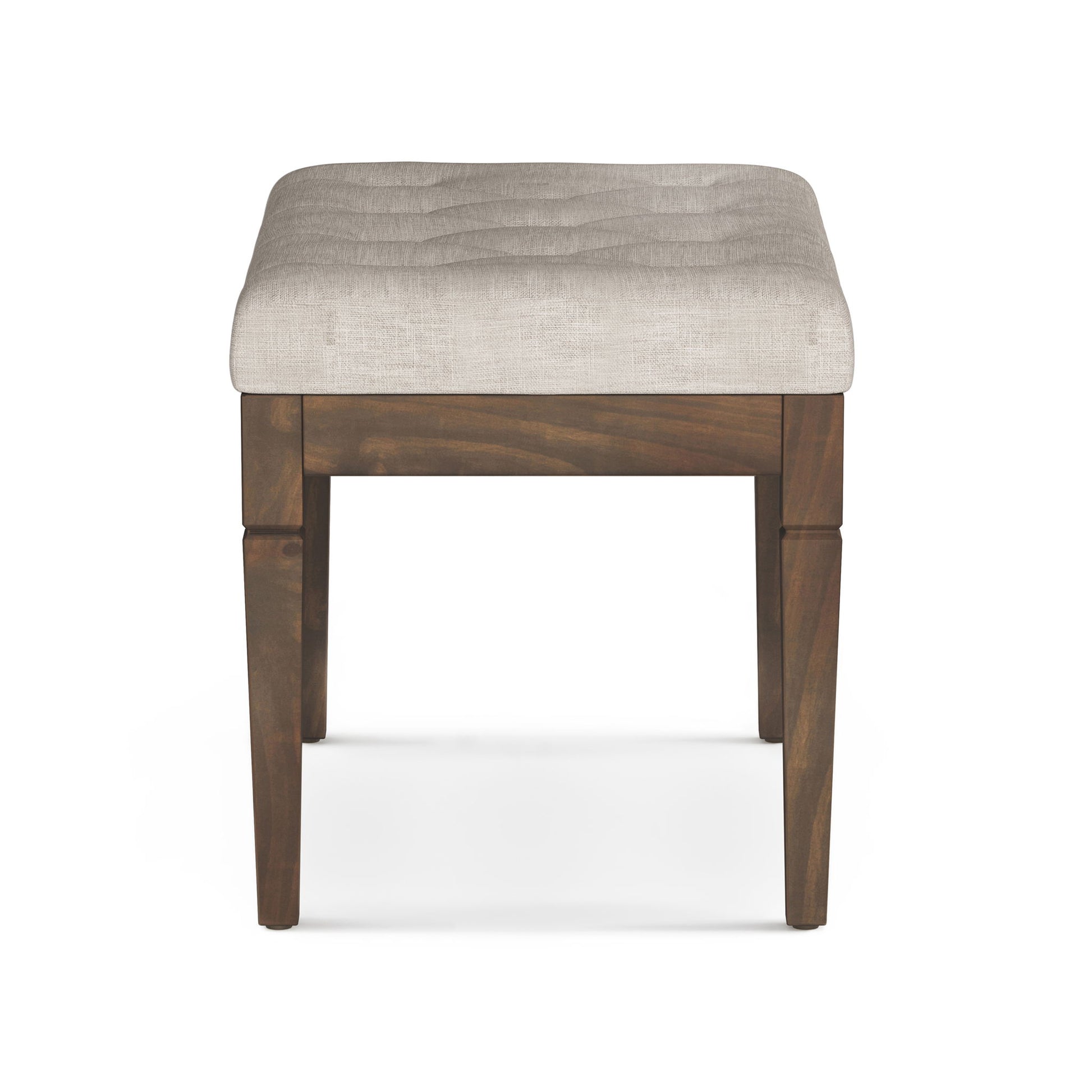 The Waverly Upholstered Tufted Ottoman Bench features a square wooden frame with four legs and a padded, light beige tufted seat, displayed from the front on a white background.