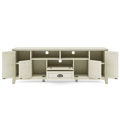 The Burlington - TV Media Stand features a cream finish, four open shelves, two side cabinets with doors, a central open compartment, and a drawer below. Circular cable management holes are located at the back.