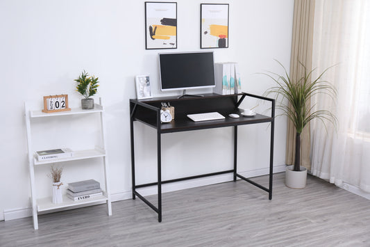 A modern, minimal home office features the Console Table Narrow Modern Entryway Table in black as a sleek desk with a monitor, keyboard, books, potted plants, and decor on a white shelving unit to the side. Sheer curtains let in natural light.