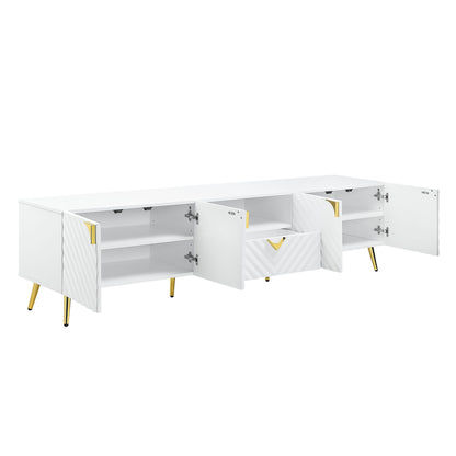 The Gaines High Gloss TV Stand in white features gold legs, two open side cabinets, a central open shelf, and a partially open drawer to reveal ample interior storage.